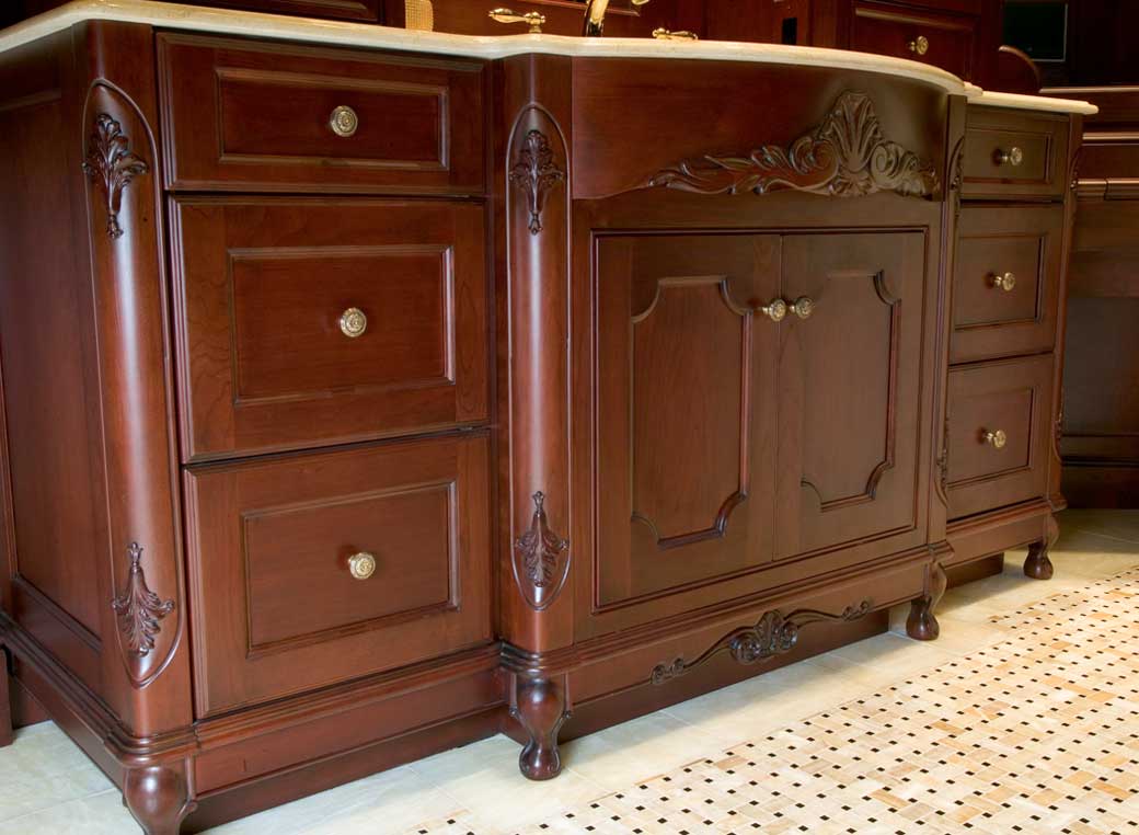 wood detailed vanity cabinets with drawers in a large formal master bath design with crown molding