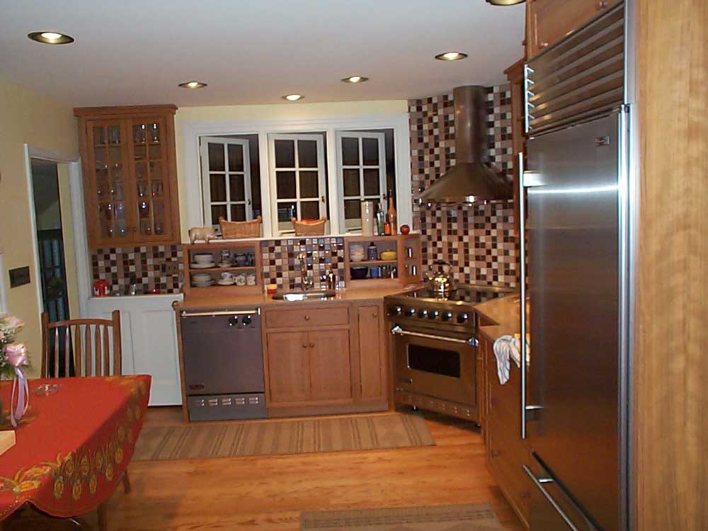Stainless steel appliances add a sleek touch design of the kitchen with a unique backsplash.
