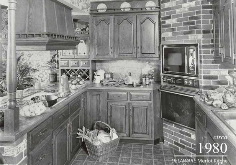 Patterned tile, an opulent range hood, and wine storage display the refinement of the vintage kitchen